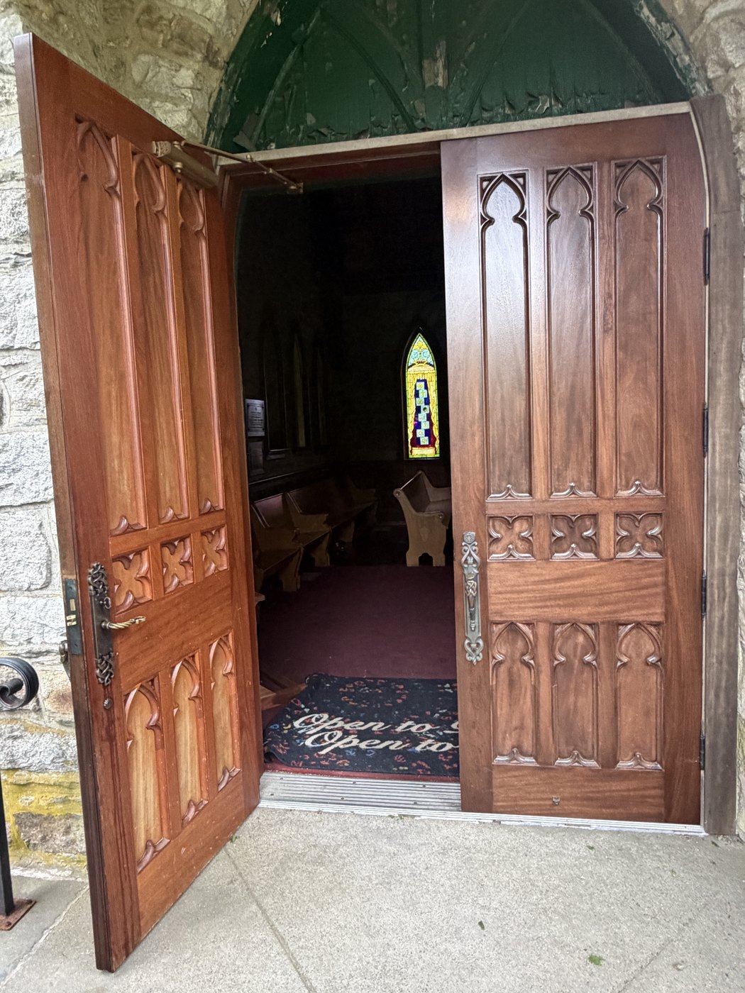 The open mahogany doors